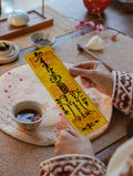 Handcrafted Taoist-inspired peace blessing talisman photographed in a calm home setting.